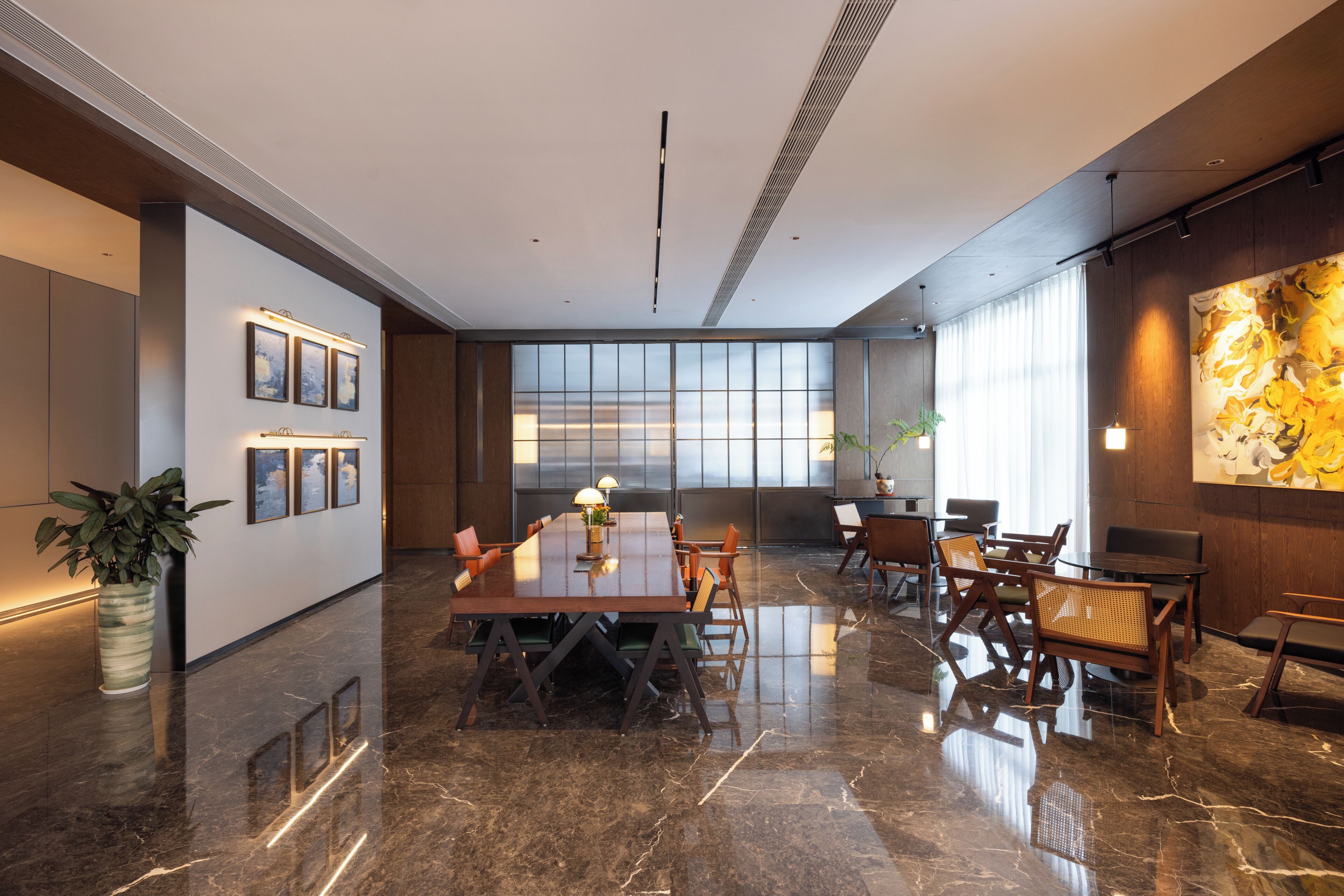 A modern conference room with a polished marble floor, a long table with chairs, and a large window with a view.