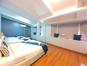 A hotel room with two beds, a large window with a view, a mirror, and a wooden floor. - MaMa Beach Pool Villa Pattaya (Muang Pattaya)