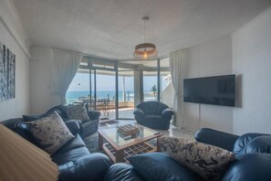 Luxury Apartment, Balcony | Living area | 55-inch TV with cable channels - Uvongo Holiday's (Margate)