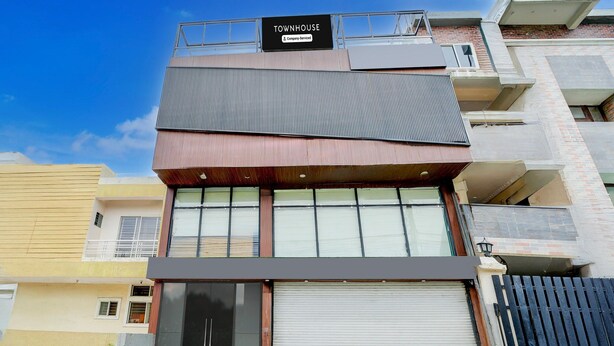 Un edificio a più piani con un cartello che recita 'TOWNHOUSE & Company Services'.