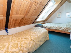 A dormitory room with two beds, a skylight, wooden walls, and a blue carpet. - 10 Person Holiday Home in Harboore (Harboore)