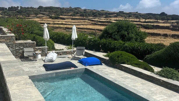 A swimming pool with a view of a hilly landscape. - A quiet Cycladic-style family home with a pool and an exceptional ocean view. (SIFNOS)