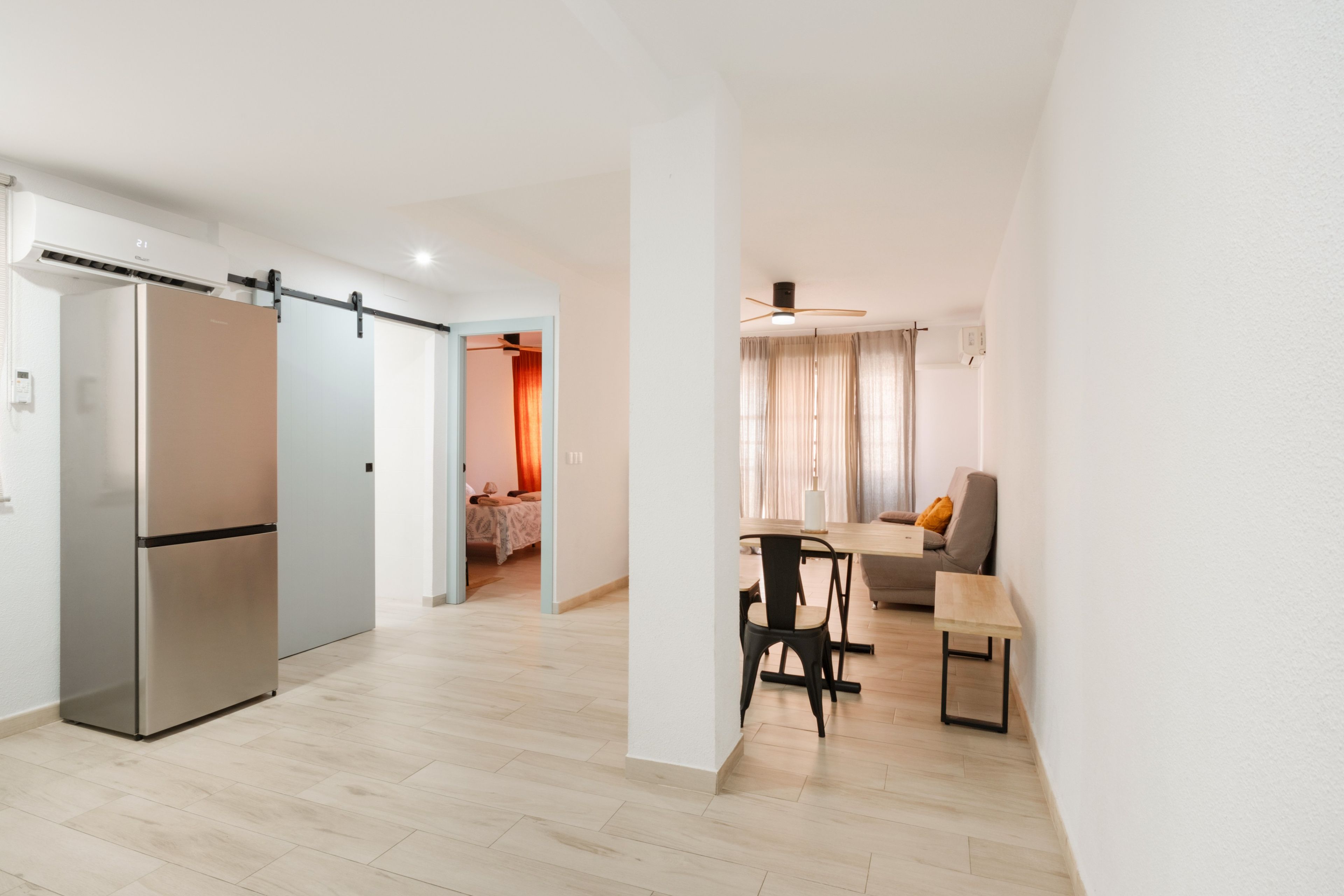 A modern apartment with a kitchen, dining area, and living room.