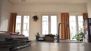 A kitchen with a sink, a potted plant, and a refrigerator. - Townhouse in smiley-neighbourhood 2060 (Antwerpen)