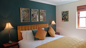 A bedroom with a bed, two nightstands, wall art, and a window. - D'Vine Maison (Franschhoek)