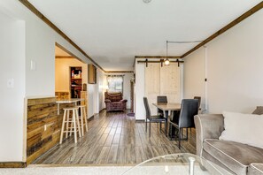 A modern interior with a kitchen, dining area, and living space. - Walk to Weirs Beach! Family Escape w/ Balcony (Laconia)