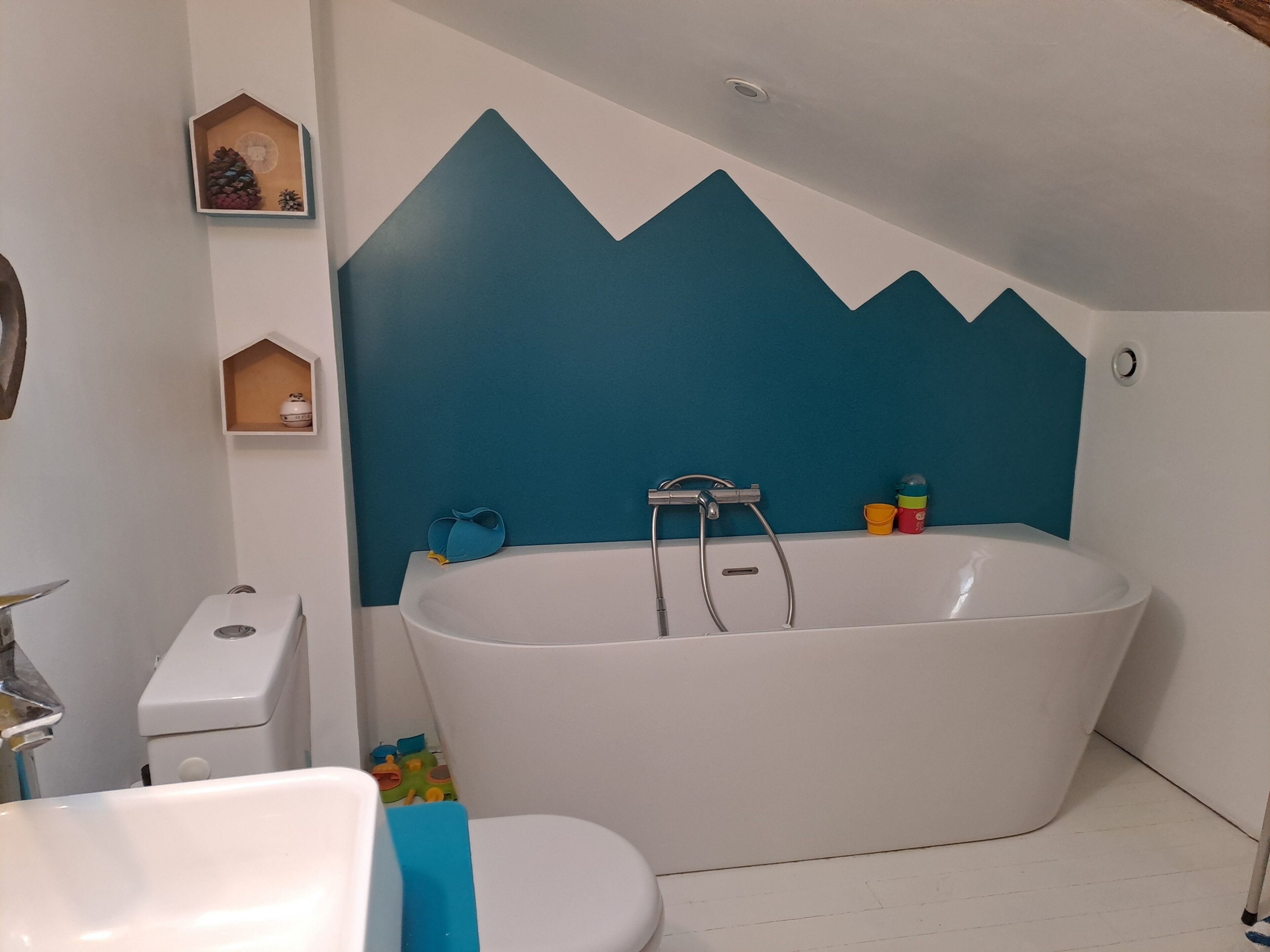 A bathroom with a freestanding bathtub, a toilet, and a sink.