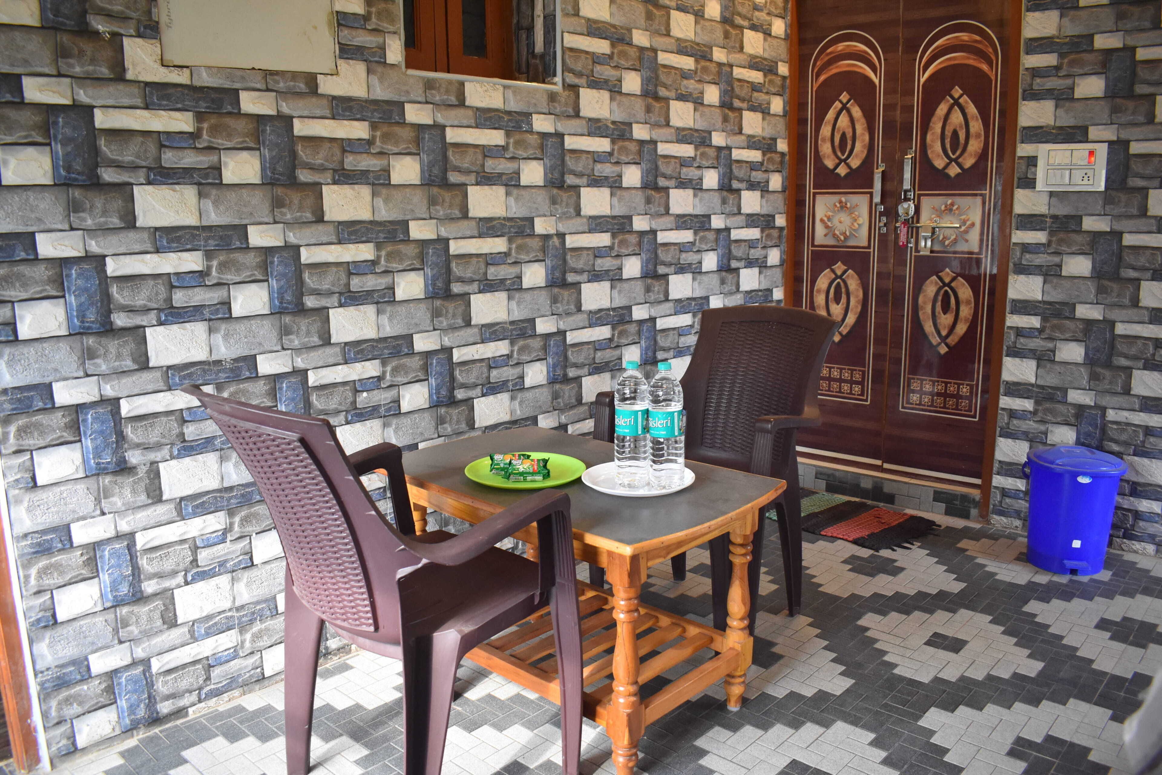 A dining area with a table, chairs, and a decorative wall.