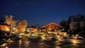 A modern house with a stone pathway and garden lighting.