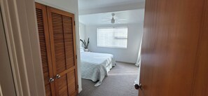 A bedroom with a bed, a ceiling fan, and a window with blinds. - Point Wells Village home with large covered deck. Pet friendly! (Point Wells)