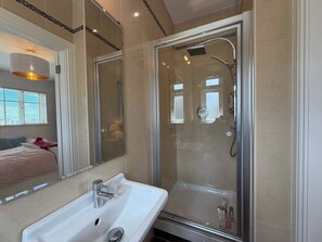 A modern bathroom with a glass-enclosed shower, a white sink, and a large mirror. - Luxury 4BDR Retreat With Garden and Workspace (Malahide)