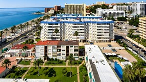 A coastal cityscape with high-rise buildings, a beach, and a clear blue sky. - Beachfront, 12th Floor with Stunning Views, Maite 2, Benalmádena (Benalmádena)