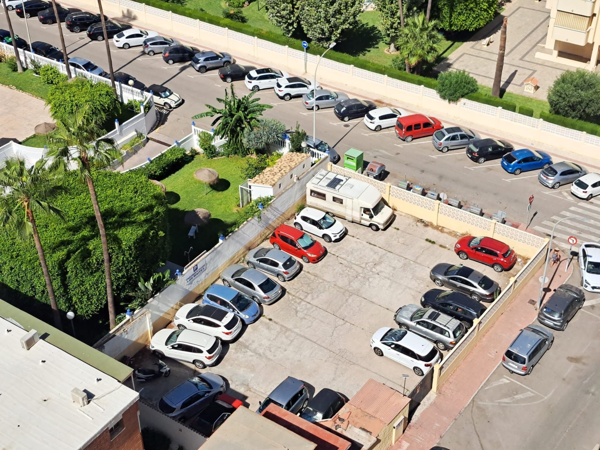 A multi-level parking structure with several cars parked on different levels.