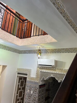 A multi-level interior with ornate tile work, a staircase, and a balcony with a railing. - Entire apartment, in the medina, rooftop, 7-minute walk from the Oudayas and the beaches. (Rabat)