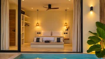 A bedroom with a bed, bedside tables, and a ceiling fan.