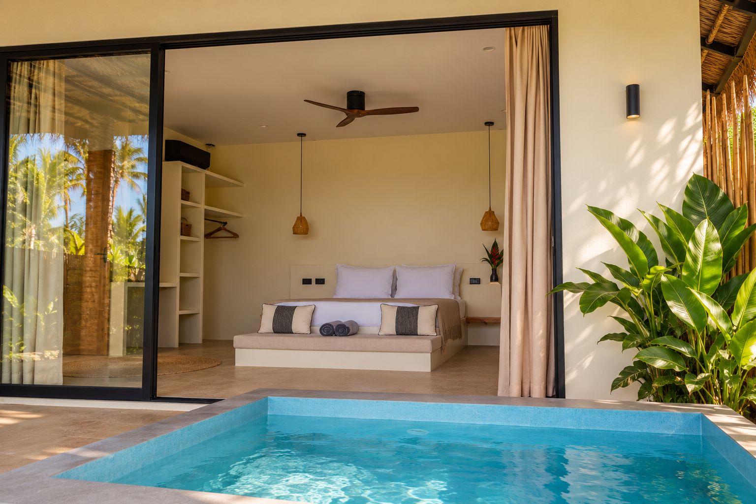 A bedroom with a bed, a ceiling fan, and a view of a swimming pool.