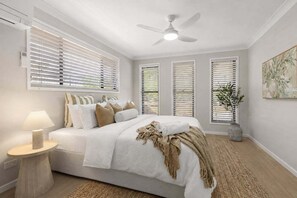 A bedroom with a bed, a ceiling fan, and a window with blinds. - Blue Gum Hideaway - Pets by approval (Sunshine Coast)