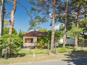 A small house with a red roof, surrounded by trees and a fenced yard. - Stefano by Interhome (Fonyód)