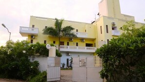 A multi-story building with balconies and a gated entrance. - blissful haven (Vanur)