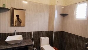 A bathroom with a sink, toilet, and mirror. - blissful haven (Vanur)