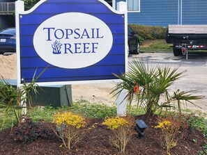 A sign for Topsail Reef with a blue and white color scheme. - Oceanfront, Beachfront Condo 219 (North Topsail Beach)