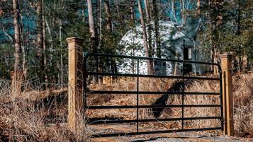 A metal gate with a sign indicating surveillance.