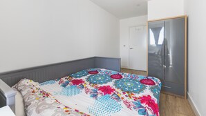 Une chambre à coucher avec un lit, une armoire et une porte.