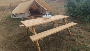 A tent with a picnic table in a grassy field. - Astial Ezquerra Experience – Nature with Charm (Sierra de la Demanda)