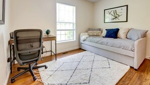 A room with a bed, a desk with a chair, a window, and a wall-mounted picture. - Serene Getaway on Private Land with Panoramic Views in Walton, New York (Walton)