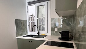 A modern kitchen with a window, a built-in sink, and a coffee machine. - Athenian Stay 305 Apartment Monastiraki (Athens)