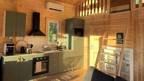 A compact kitchen with a stove, oven, sink, and a window. - Log cabin with hot tub and views (Bondemölla)