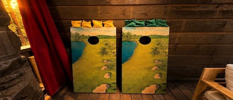 Two wooden doors with tropical beach scenes and a red curtain.