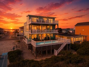 A multi-story beachfront building with a pool, deck, and multiple balconies. - Sea-Batical: a 9-bedroom: Priv. Pool w Opt. Heat, Hot Tub, Oceanfront (Oak Island)
