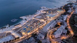 An aerial view of a coastal area with a marina, buildings, and a sports complex. - Rećina, Studio apartment near Žnjan Beach (Split)