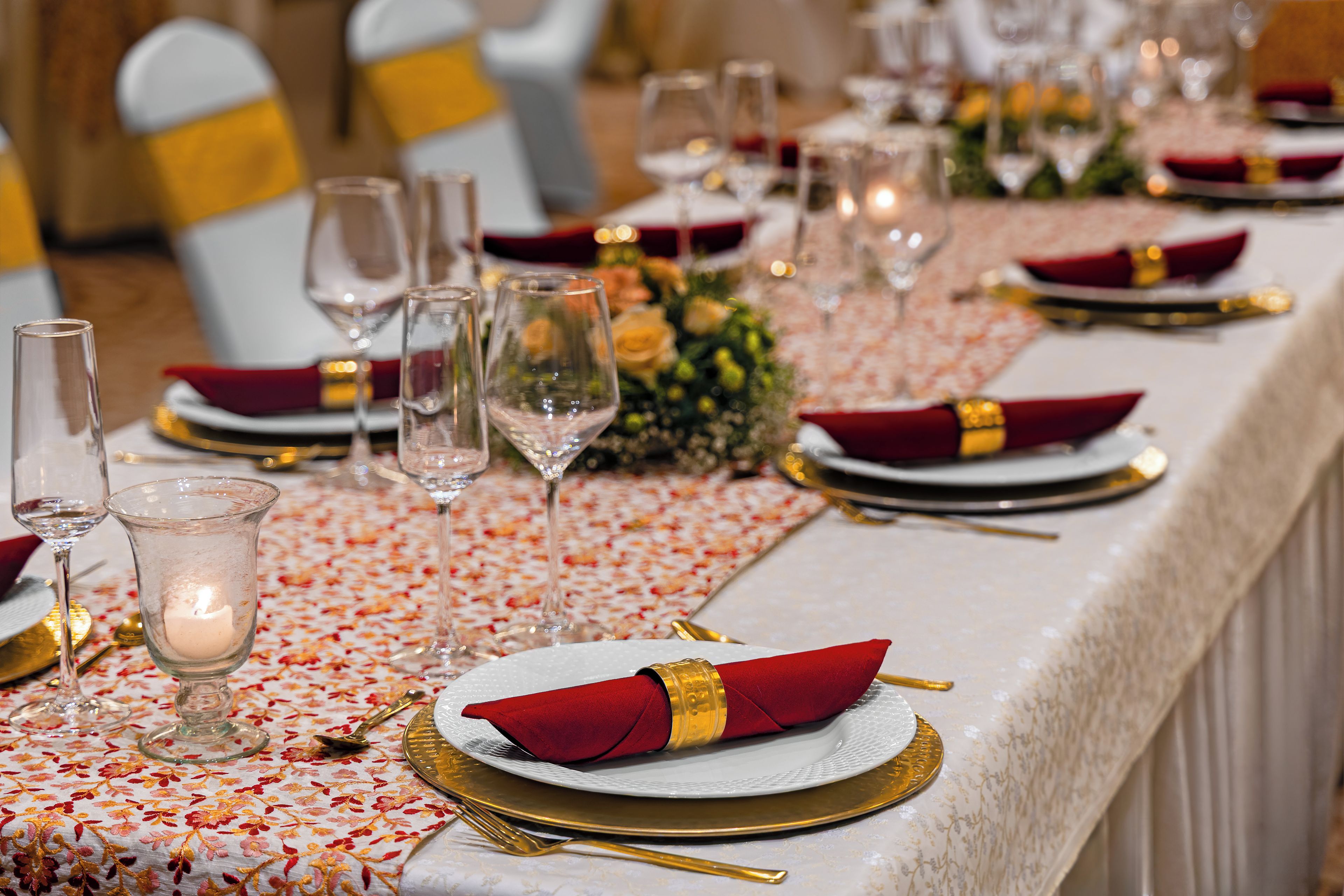 A table set for a formal event with glassware, plates, and napkins.
