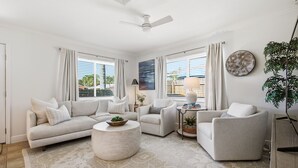 A living room with a sofa, armchairs, a coffee table, and a plant. - Private Tropical Oasis • Heated/Cooled Pool (Naples)