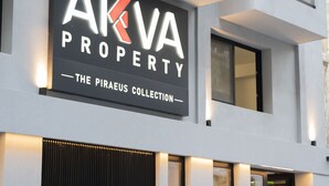 A building with a sign reading 'AKVA PROPERTY - THE PIRAEUS COLLECTION'.