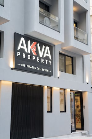 A building with a sign reading 'AKVA PROPERTY - THE PIRAEUS COLLECTION'. - AKVA Property - The Piraeus Collection (Pireas)