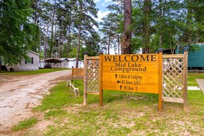 A campground sign with directions to cabins, RV rows, and a lodge.