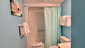 A bathroom with a shower, toilet, and towel rack. - Oceanfront bliss awaits in this 1-bedroom condo 0804 (Carolina Beach)