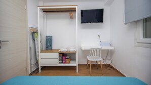 A bedroom with a bed, a desk, a chair, a TV, and a wardrobe. - GREEN ALMOND D1.2 FAMILY FRIENDLY (Paralia Ofriniou)