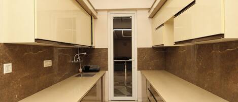 A narrow kitchen with two counters, a sink, and cabinets.