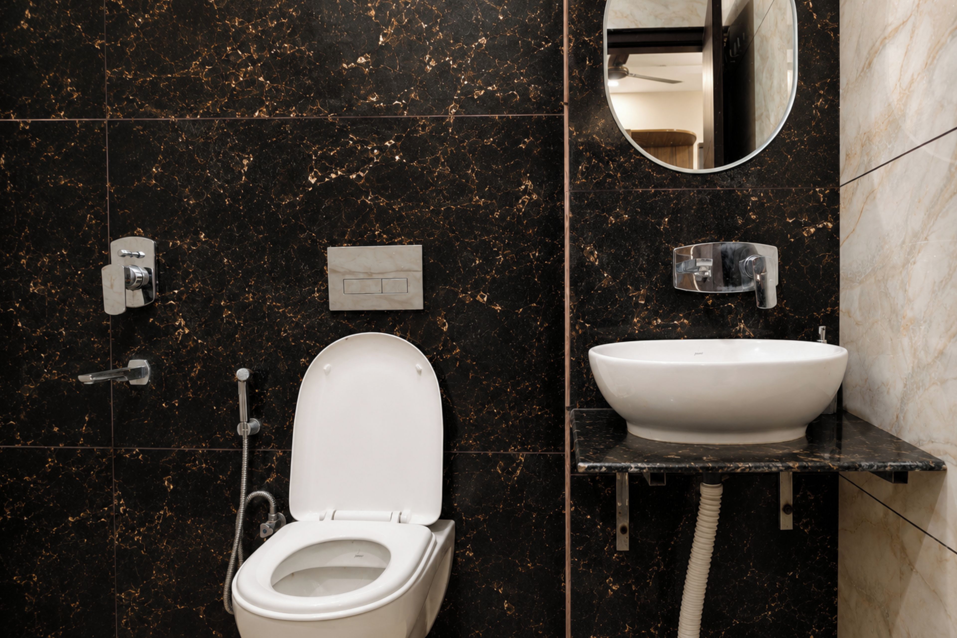 A modern bathroom with a toilet, bidet, and sink.