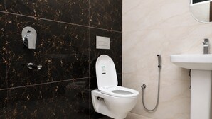 A modern bathroom with a toilet, bidet, and sink. - Aarambh Hillside View (Dehradun)