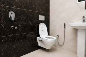 A modern bathroom with a toilet, bidet, and sink. - Aarambh Hillside View (Dehradun)