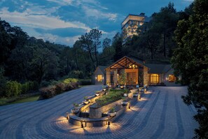 A modern house with a large glass facade, surrounded by a landscaped garden with pathways and planters. - Himalayan Woodcroft, Sirmaur - IHCL SeleQtions (Pachhad)