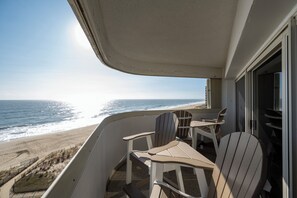 Ein Balkon mit Blick auf Strand und Meer.