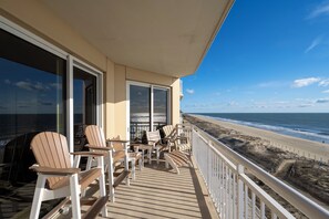 A balcony with Adirondack chairs overlooking a beach. - Gateway Grand 510 Storage locker included and new decorator furnishings!! (Ocean City)