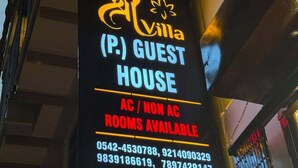 A sign for a guest house with the name 'Villa' and contact numbers. - Shree Villa Guest House (Varanasi)