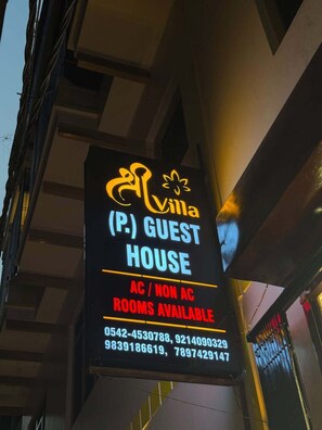 A sign for a guest house with the name 'Villa' and contact numbers. - Shree Villa Guest House (Varanasi)